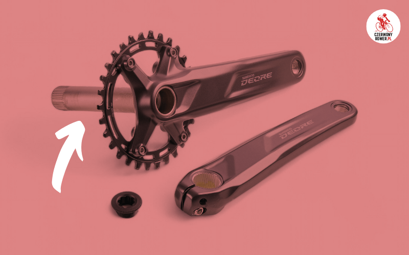 Korba Shimano Deore z systemem Hollowtech II i zintegrowaną rurką osiową.